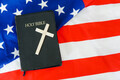 Old Holy Bible with a cross on american flag. Copy space. - PhotoDune Item for Sale