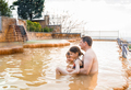 Family, dad and children bathe, swim in outdoor dirty hot springs. Thermal water bath pool and  - PhotoDune Item for Sale