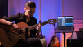 Man plays guitar. Young man plays a musical instrument. Musician records his composition.  - PhotoDune Item for Sale