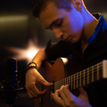 Man with a classical guitar in a neon glow. Teenager plays guitar. Young man plays a music - PhotoDune Item for Sale
