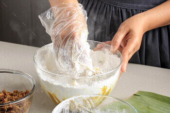 r on Clear Mixing Bowl. Process Making Indonesian Traditional Food from Steamed Sweet Potato Called Mendut or Nagasari. Action Photography