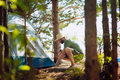 caucasian man wearing a hat putting up a tent. Family camping concept - PhotoDune Item for Sale