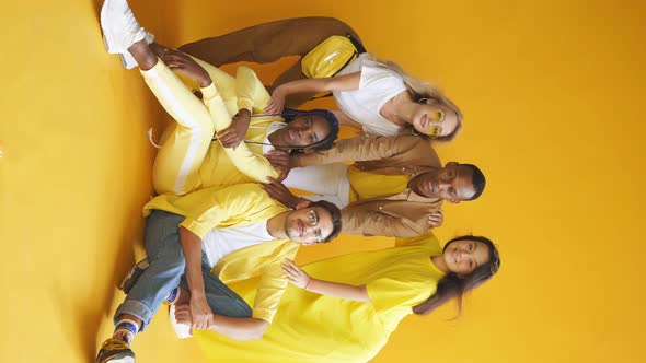 International Group of Happy Friendly Smiling Men and Women Isolated on Yellow Background Studio