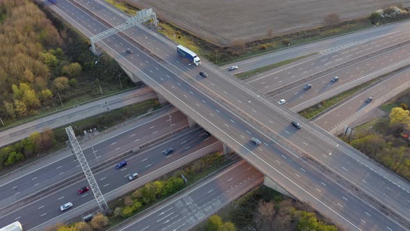 Vehicles Driving on a Motorway at Sunset Using Bridge Infrastructure