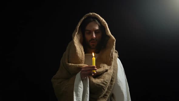 Male Alike Jesus Blowing on Candle After Gospel, Praying God, Spirituality