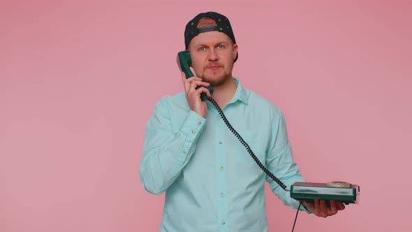 Cheerful Tourist Man Secretary Talking on Wired Vintage Telephone of 80s Says Hey you Call Me Back