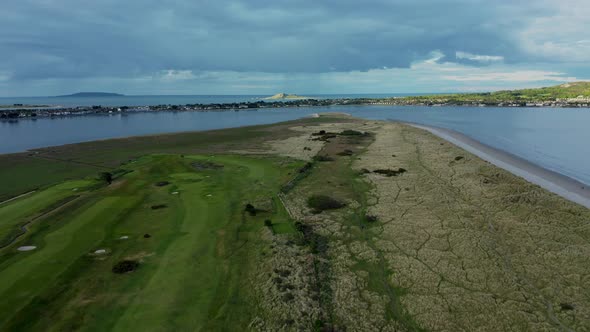 Aerial view over Irish beach textured dunes and golf course