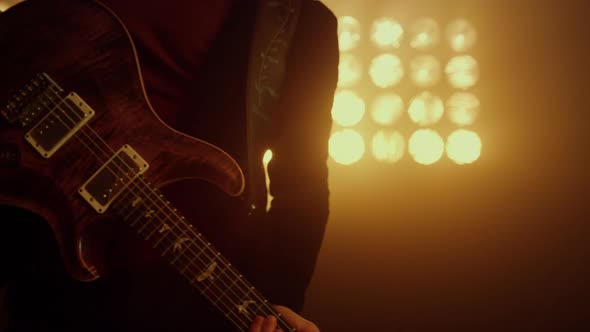 Professional Guitarist Holding Guitar on Stage Close Up