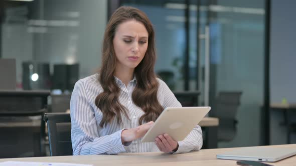 Young Businesswoman Reacting to Loss on Tablet at Work