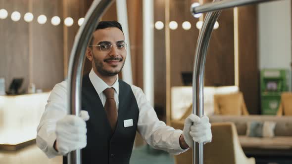 Portrait of Porter with Luggage Cart in Hotel