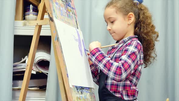 Process of Drawing: In Artist's Art Studio Hand Baby Girl Sketching on Canvas.