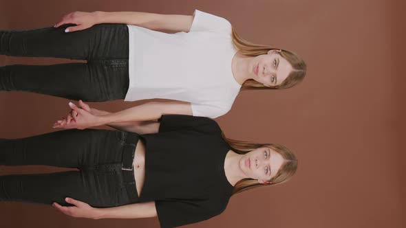 Vertical Portrait of Twins Looking at Camera