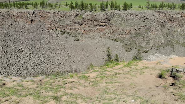 Broken Crumbled Rocks Spilling From the Narrow Canyon Slope Ridge Towards the Deep Valley Floor