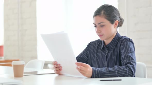 Young Indian Woman Reading Documents 