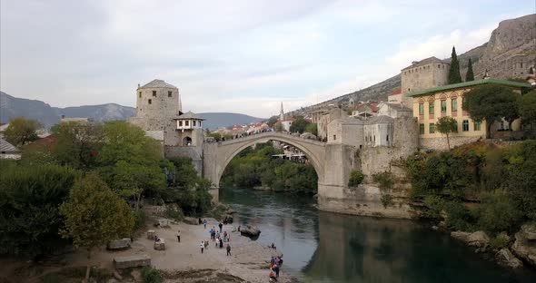 Stari Most, old bridge in Mostar. The camera slowly rises up to reveal a wide shot of the old town