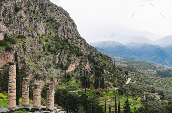 lphi Oracle, Greece, ancient greek columns against majestic mountain landscape.