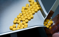 Selective focus on yellow tablets pills on stainless tray with blur hand of pharmacist or pharmacy  - PhotoDune Item for Sale