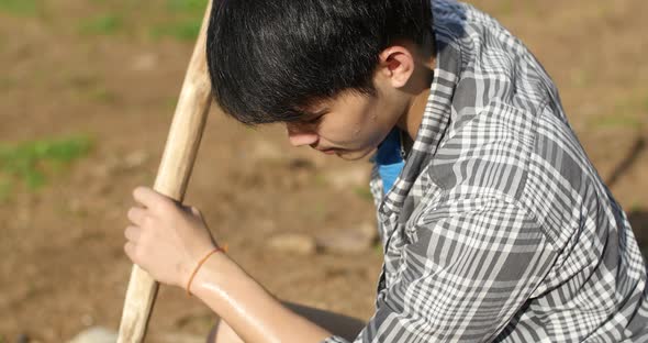 Man Digging The Hole For Planting Tree In Garden