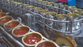 Canned fish factory. Food industry.  Many can of sardines on a conveyor belt. Sardines in red tomato - PhotoDune Item for Sale