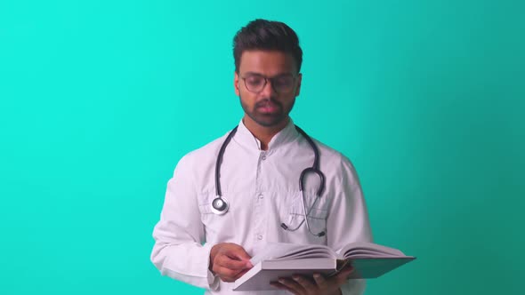 Pakistanian Doctor in White Coat with Stethoscope Feeling Confident Mock Up Over Blue Studio