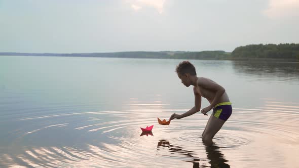 Little Boy Launch Paper Ship on the Water