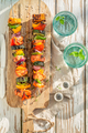 Tasty and hot grilled skewers served with water in garden. - PhotoDune Item for Sale