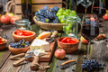 Supper with wine and appetizers on wooden table in garden - PhotoDune Item for Sale