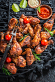 Tasty roasted chicken leg on black metal grill plate. - PhotoDune Item for Sale