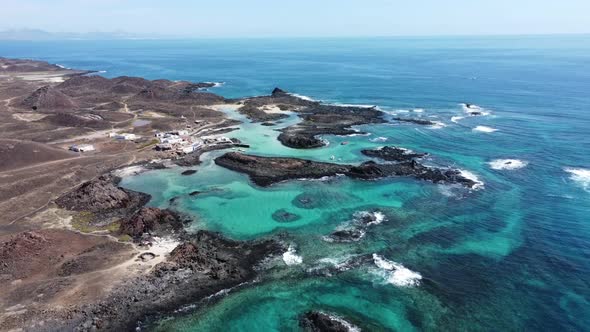 Aerial 4k footage of a view of the rugged turquoise coastline of the Island of Wolves in the Canary