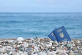 Two biometrical ukrainian passports on sea shore background - PhotoDune Item for Sale