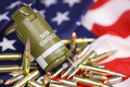 M18 smoke grenade and many yellow bullets and cartridges on United States flag - PhotoDune Item for Sale