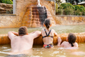 Family, dad and children bathe, swim in outdoor dirty hot springs. Thermal water bath pool and  - PhotoDune Item for Sale