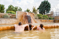 Family, dad and children bathe, swim in outdoor dirty hot springs. Thermal water bath pool and  - PhotoDune Item for Sale