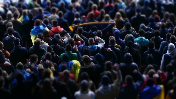 Cheerful Football Fans Waving Hands, Supporting Team at Stadium During Match