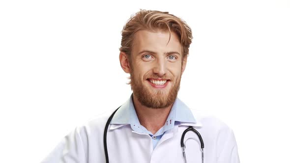 Confident Caucasian Male Doctor with Light Beard Wearing Medical Overall Showing Ok with Fingers on