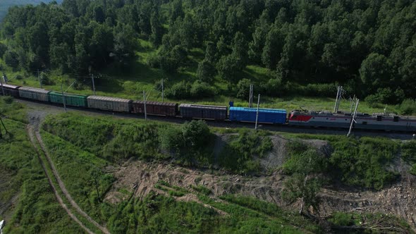 Baikal Russia  2021 A Passenger Train Rides Along the Mountains on a Sunny Day