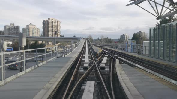 The Millenium Line Sky Train In Vancouver Metro Above The Highways Surrounded With Tall Buildings Un