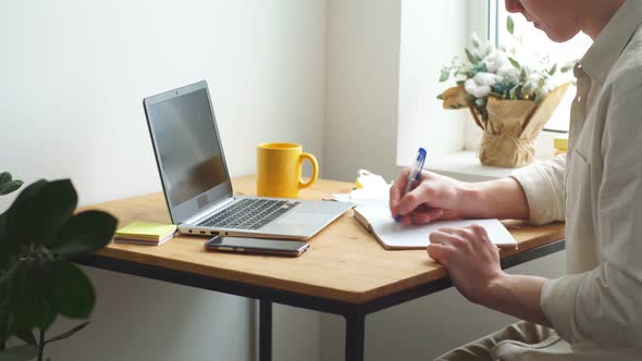 Happy Handsome Blonde Man Making Notes, Writing Someting on His Diary