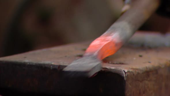 Close-up shot of metal being hammered.