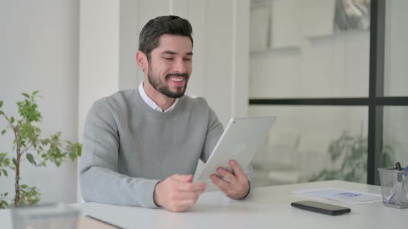 Young Man Making Video Call on Tablet in Office