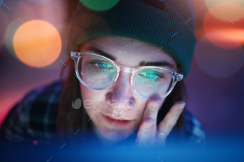 Coding, face and serious woman working overtime at night programming a computer, website or app dev