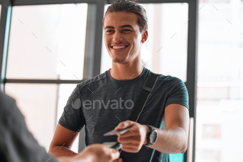 Credit card, man smile and payment at gym for fitness membership or exercise subscription. Fintech