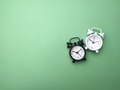 Black and white alarm clock on a green background - PhotoDune Item for Sale