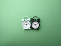 Black and white alarm clock on a green background. - PhotoDune Item for Sale