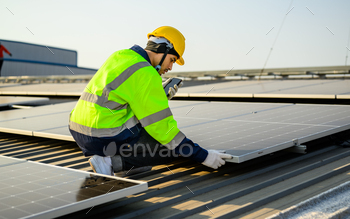 Engineer with helmet working at solar cell power plant with sunset in evening
