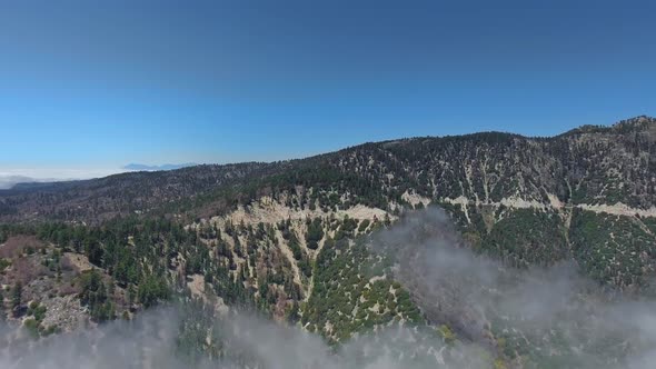 Footage of forest-covered hills, skies and clouds on the slopes near Big Bear Lake, California, USA