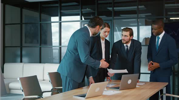 Corporate business team in a meeting. Group of young people in suits in the office