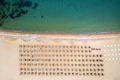 Aerial view of an stunning beach with wooden umbrellas, and calm sea. - PhotoDune Item for Sale