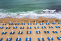 fantastic beach with, blue lounge chairs, umbrellas, and turquoise sea. - PhotoDune Item for Sale