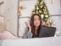 woman in cozy grey knitted sweater using laptop on bed , xmas holiday - PhotoDune Item for Sale